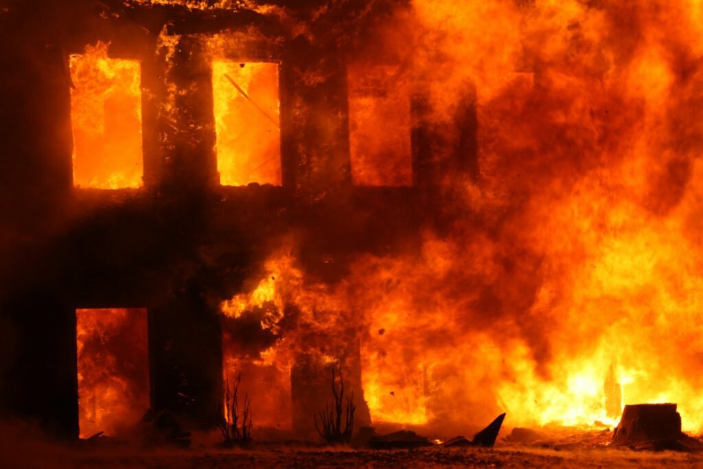 Dramatic scene of a building engulfed in flames, showcasing the power and danger of fire.